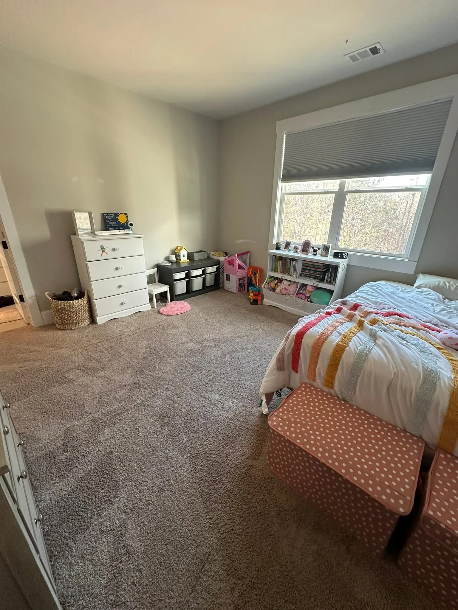 The same kids bedroom tidied with vacuumed carpet and a made bed after a residential cleaning visit