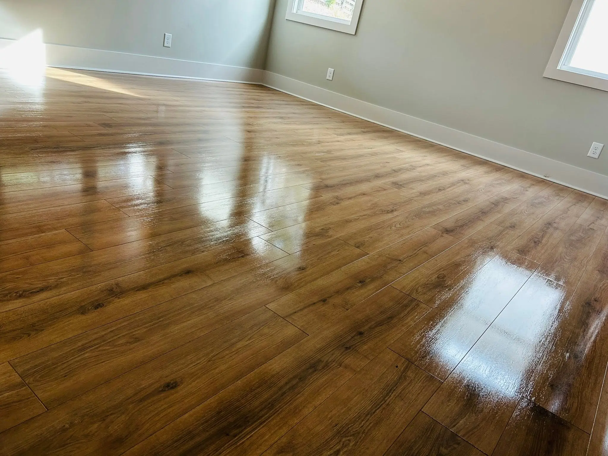 Polished hardwood floor reflecting daylight after a professional floor cleaning