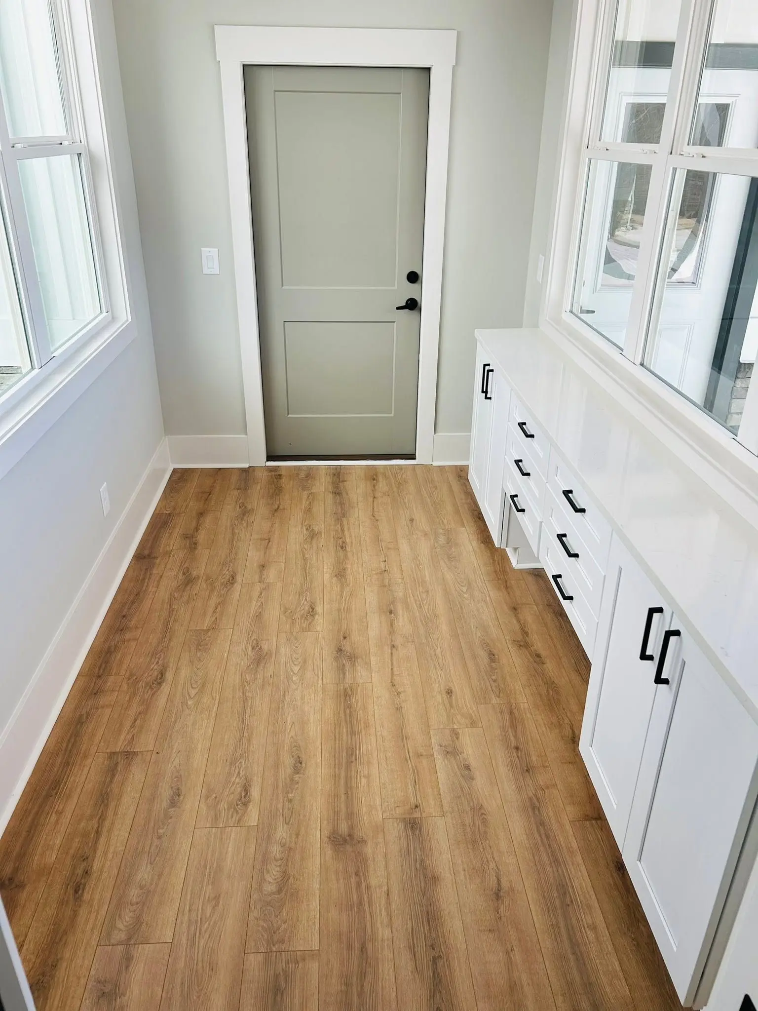 Mudroom with luxury vinyl plank flooring cleaned and cabinetry wiped down