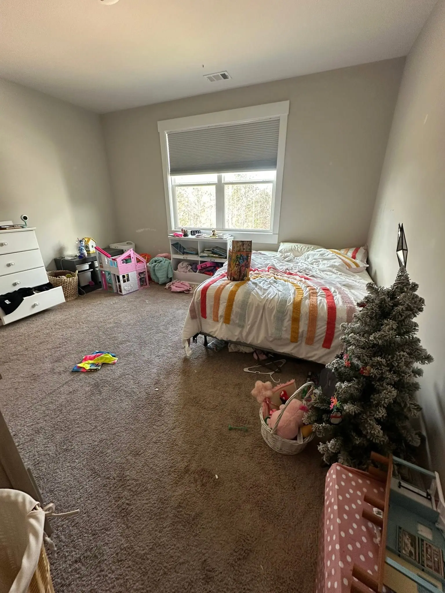 Kids bedroom scattered with toys and holiday decor before a scheduled deep clean