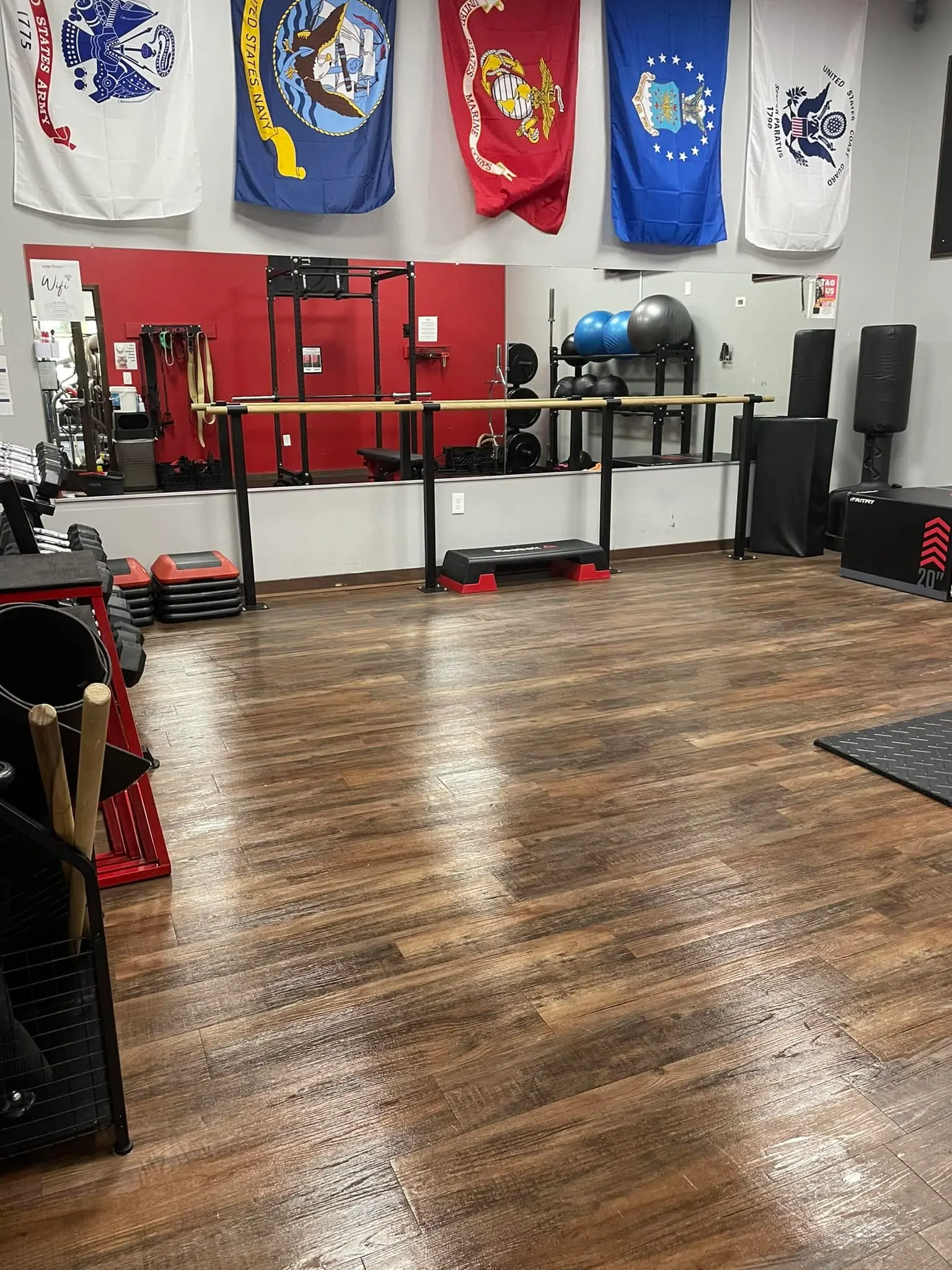 Commercial gym studio in Sharpsburg with freshly mopped hardwood flooring and dusted equipment racks