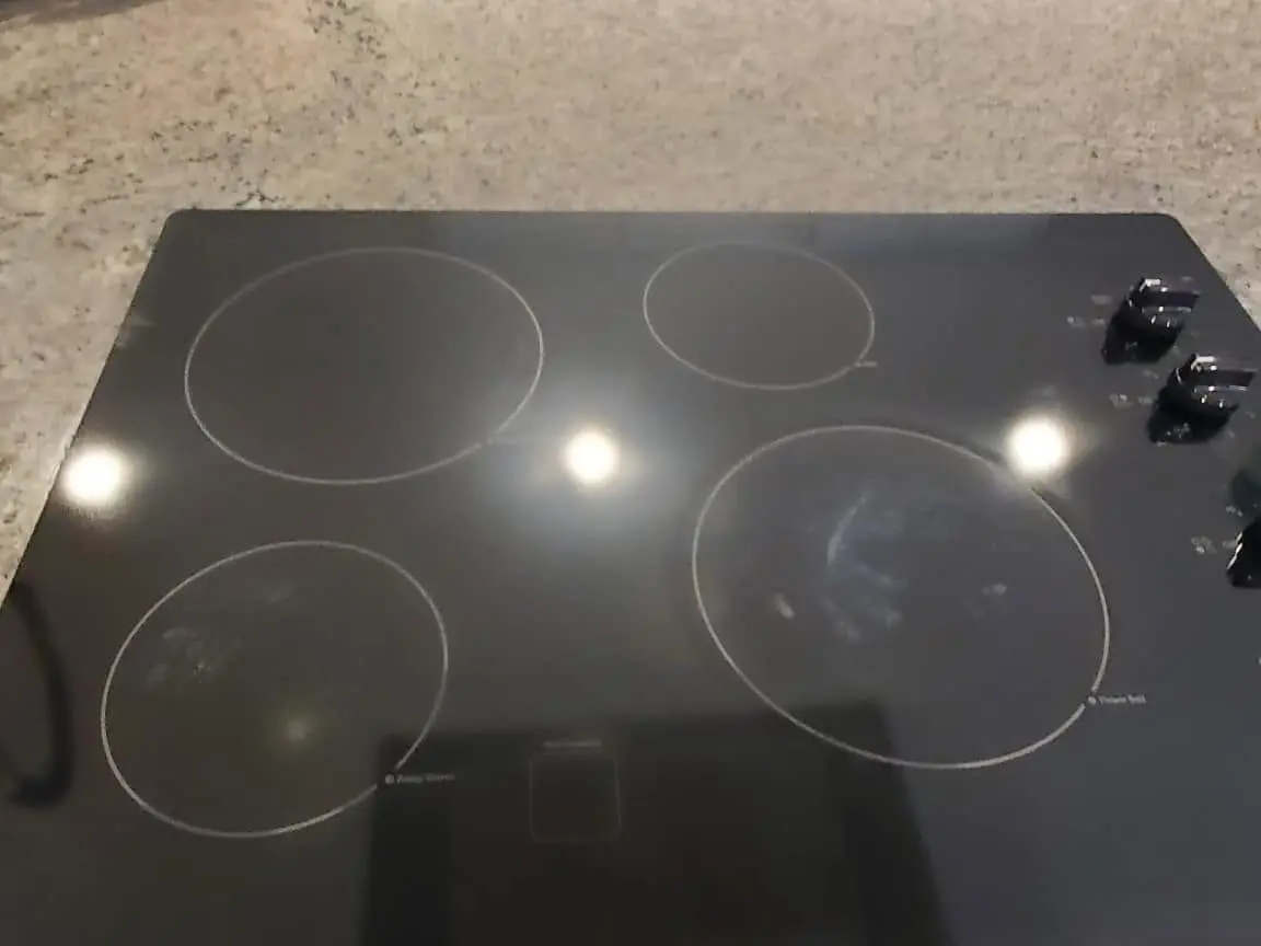 Black glass cooktop polished streak-free after Fresh As A Daisy kitchen detailing