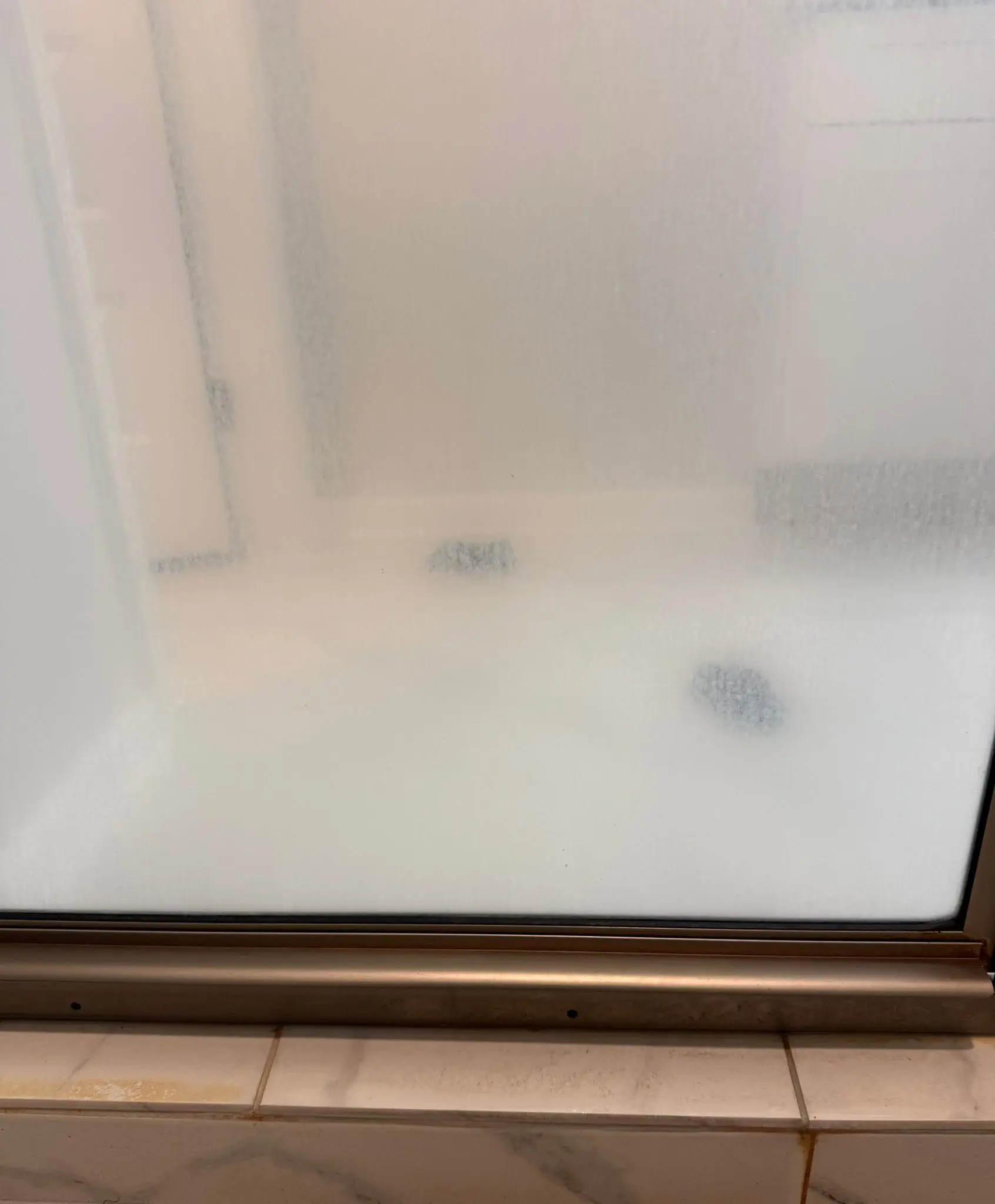 White shower base and threshold cleaned during a move-out property turnover